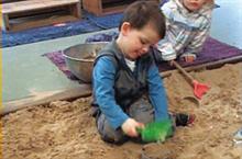 Scott exploring containers of sand Scott exploring containers of sand