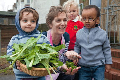 Nursery teacher Alison Bartlett in the veg patch with children from winners Hertford Infant and Nursery School