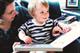 Orson reads a book with his mother