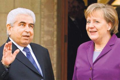 Differences: Dimitris Christofias and Angela Merkel (Credit: Getty)