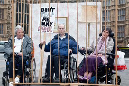 Fighting to get out: disabled people pose behind bars to highlight their campaign, supported by a huge rally in London