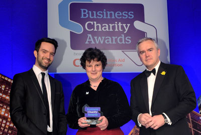 Business Charity Award winner Kate Neville with Third Sector's Alex Hay [left] and BBC News presenter Huw Edwards