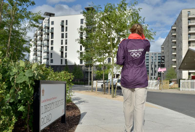 A Games Maker walking through the Olympic Village