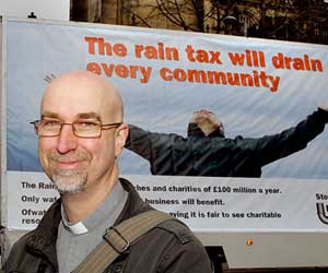 Reverend Andy Salmon with a campaign poster