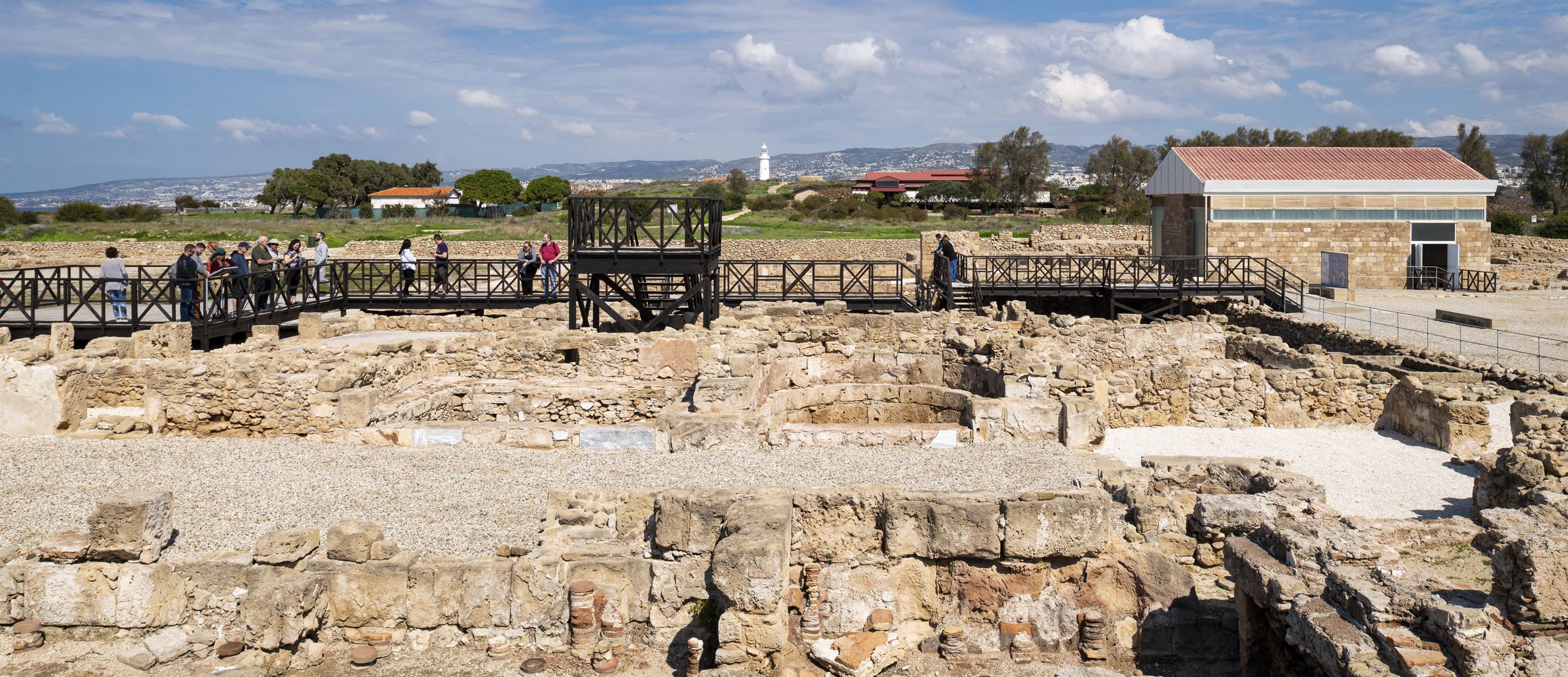 Seen in the foreground, a large bath complex was
buried to protect the mosaics until they can be
sheltered. Also pictured, the two protective
shelters now on the site at the House of Aion and
the House of Dionysus. Photo by Scott Warren.
Courtesy of the J. Paul Getty Trust