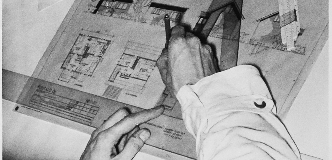 A draughtsman finishes work on a sheet of drawings in the early 1950s at the Helsinki office of the Puutalo company.
© ELKA