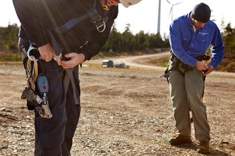 The technicians fit climbing harnesses before tackling the 95-metre climb to the nacelle