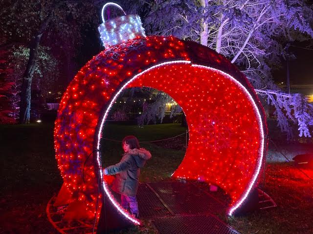Child in red tube feature at Christmas at Kew