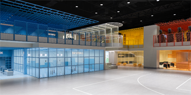 basketball court of colour indoor gym, showing blue, red and yellow workout zones