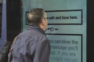 Cancer Research UK interactive poster asks passersby to 'blow here'