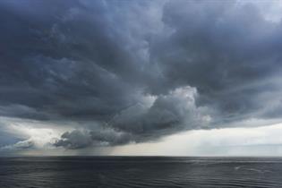 A photo of the sea, with storm clouds gathering above