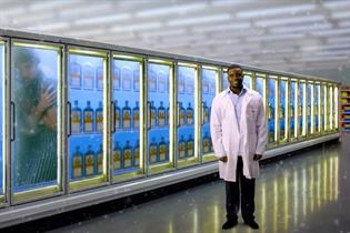 Actor, rapper and comedian Michael Dapaah stands in front of a bank of freezers containing bottles of Jagermeister