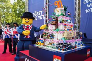 Lego man with giant lego 90th birthday cake