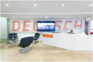 Deutsch New York office reception with large desk and tv on the wall