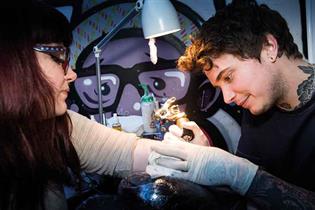 That inking feeling: a brave guest gets tattooed at Campaign Underground