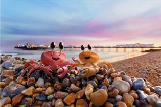 Still from Freesat ad showing two animated crabs on a pile of pebbles on a beach