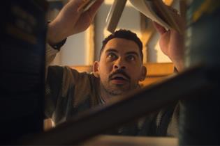 Man looking through a bookcase