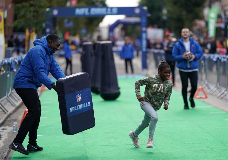 A child taking part in NFL drills