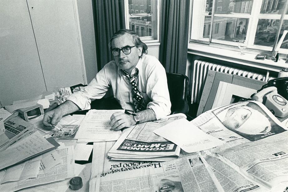 Archive photo of Jeremy Bullmore in front of lots of papers in 1977
