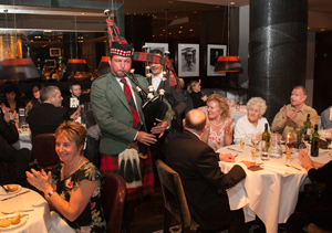 Guests enjoy the piper during Burns Night at Marco's
