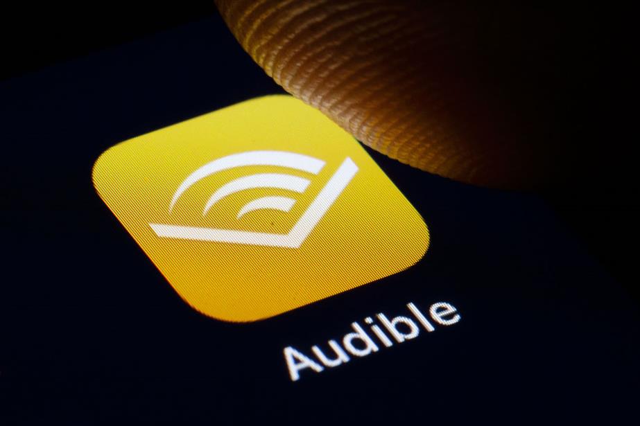 Photo of a thumb pressing an Audible app image (Getty Images)