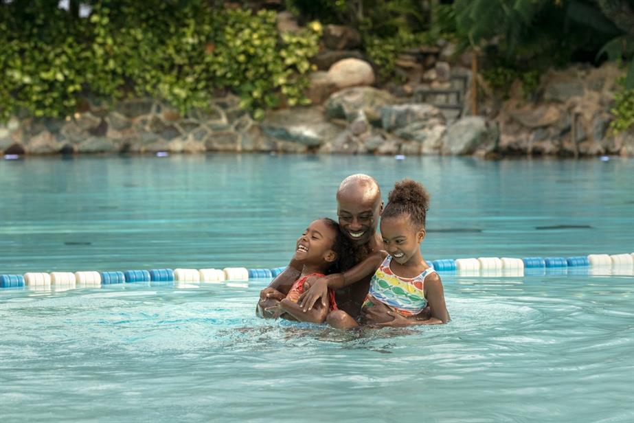 Image from Center Parcs campaign of father and two children swimming