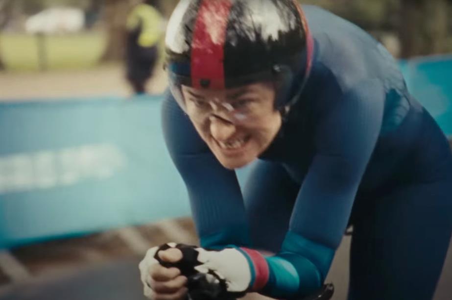 A still of a cyclist with determined expression on their face competing at the Paralympics 