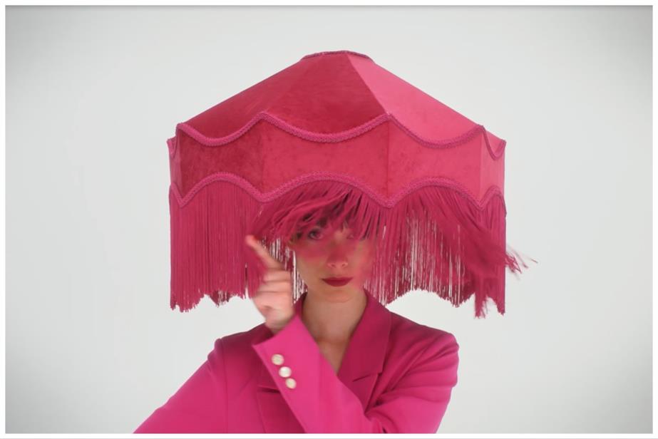 A woman wearing a lampshade on her head
