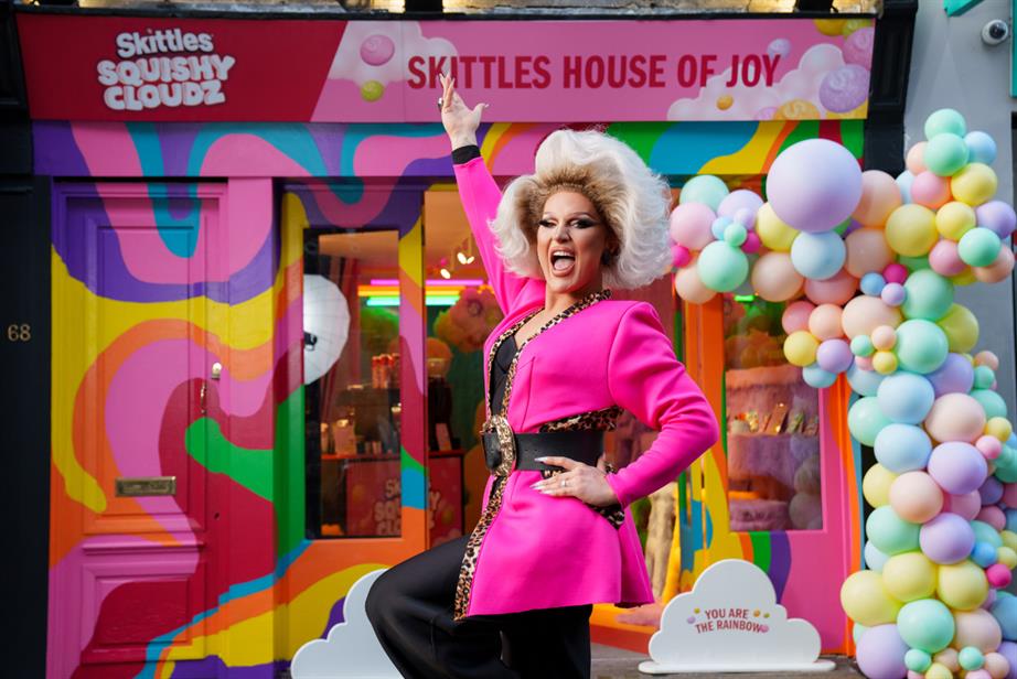 The Vivienne standing in front of The Skittles House of Joy