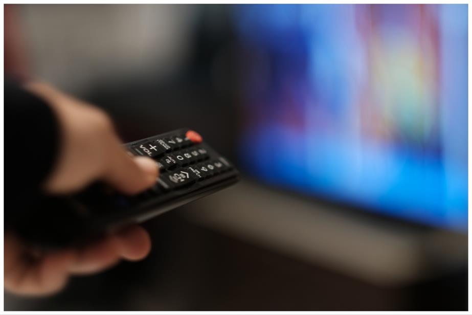 Hand pointing remote at TV