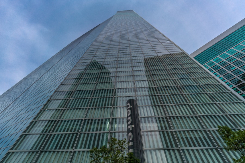Huge Dentsu skyscraper with company logo outside