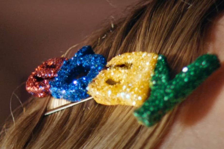 A hairclip with "EBay" on it in glittery red, blue, yellow and green letters.