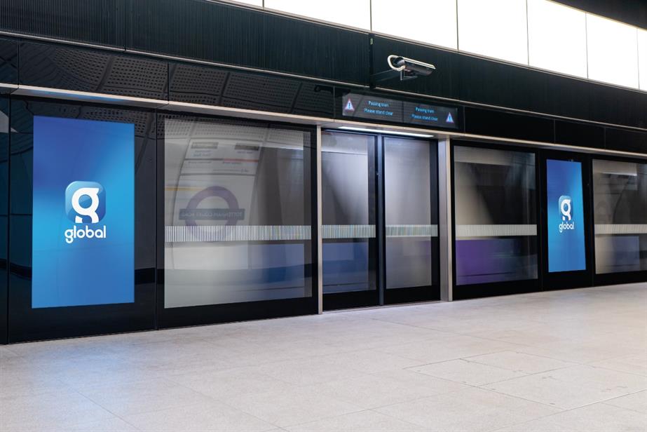 A tube platform with digital screens showing the Global logo