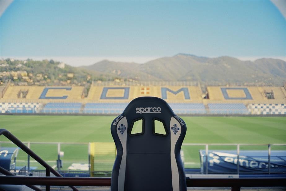 An empty chair in front of a football stadium