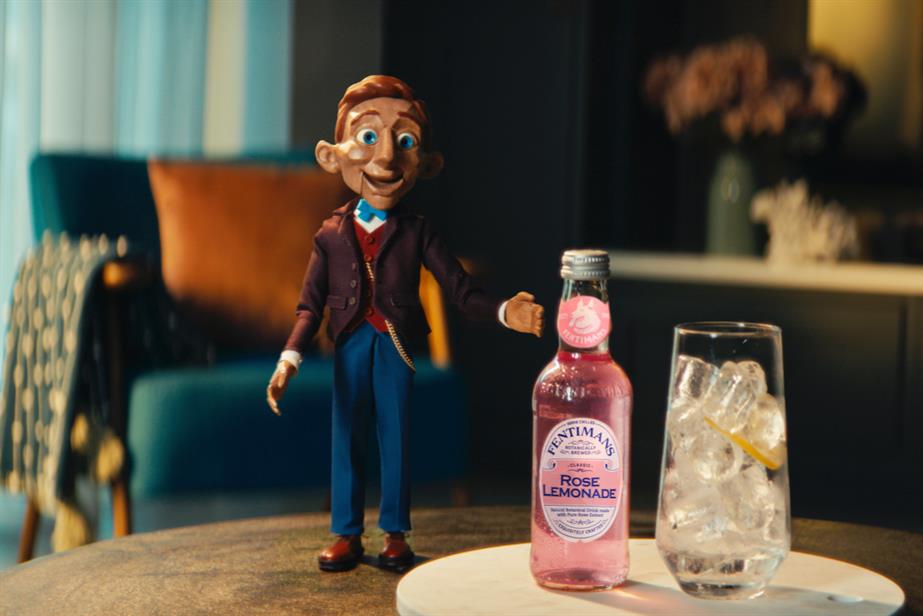 an immaculate little puppet man gestures at a bottle of Fentimans 