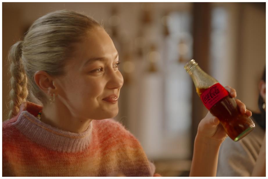 Supermodel Gigi Hadid holds a bottle of Coca-Cola