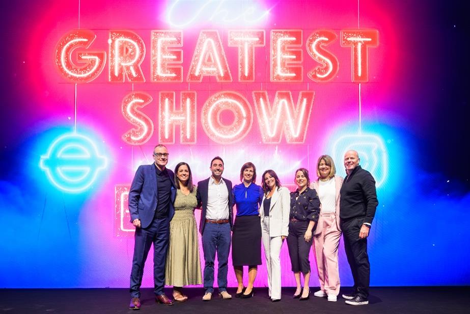 Global's team pose in front of "The greatest show under Earth" event logo.