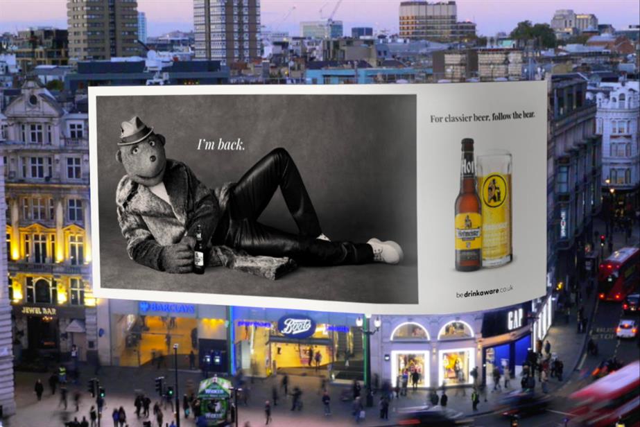 Digital billboard of George the Bear posing with a beer