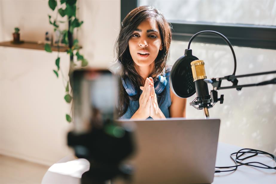 Stock photo of a woman recording a video