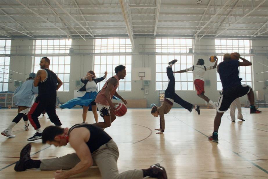 Still from ad showing basketball players and dancers moving together