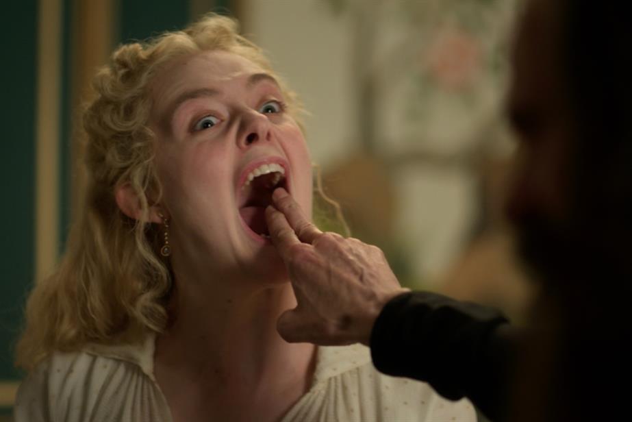 Still from The Great of Elle Fanning biting someone's finger