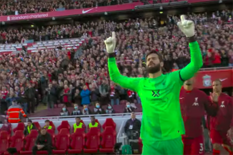 Liverpool goalkeeper Alisson walks out onto the Anfield pitch