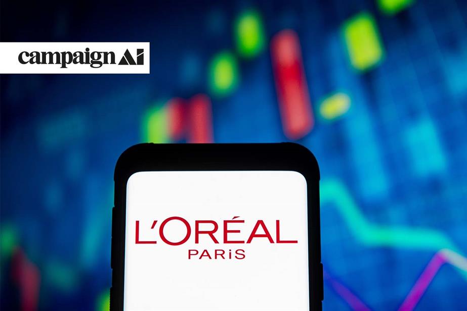 L'Oreal  Paris logo on a smartphone with a graph in the blurred background