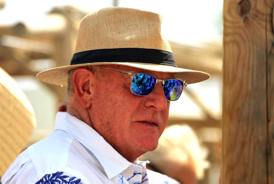  A photo of Mark Howe wearing a hat and sunglasses