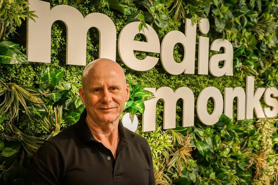 Matthew Godfrey in front of MediaMonks branding and jungle-style foliage