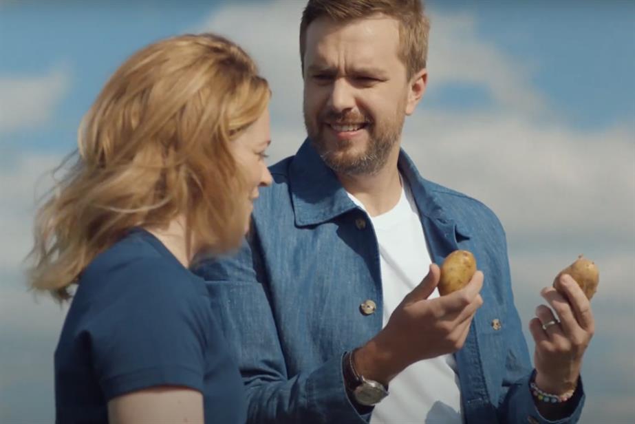 Imogen Stanley standing with Iain Stirling holding potatoes 