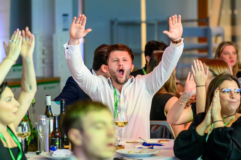 man cheers at table
