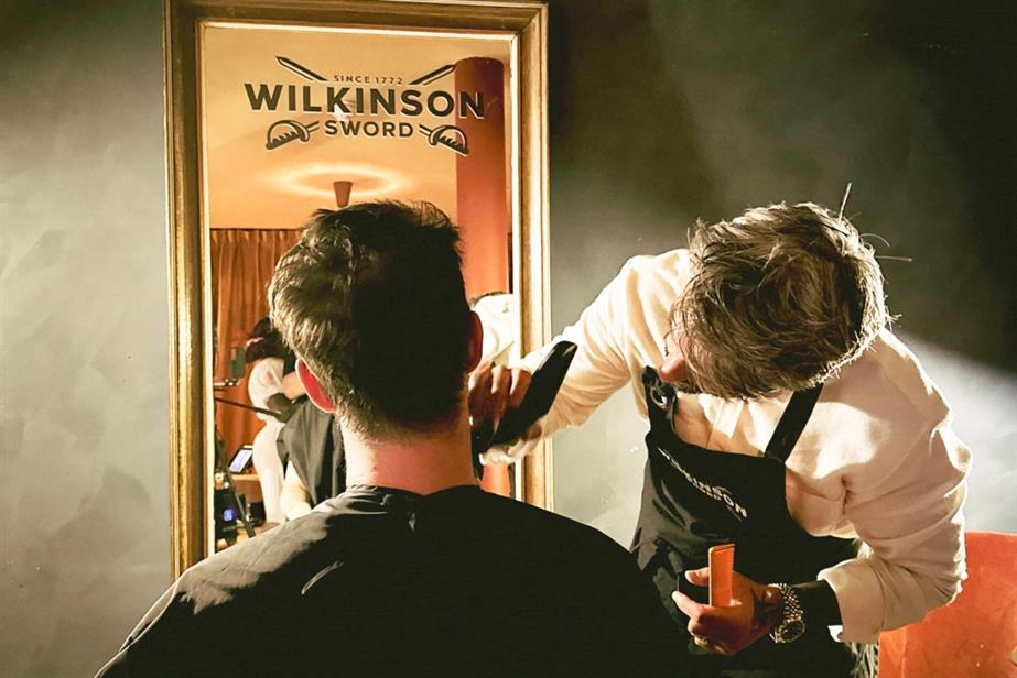 Man getting beard shaved by a barber