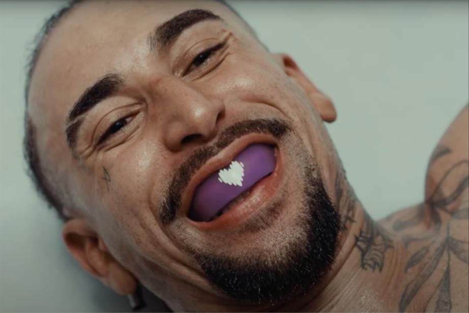 Boxer on floor smiling with a Deezer-branded mouth guard