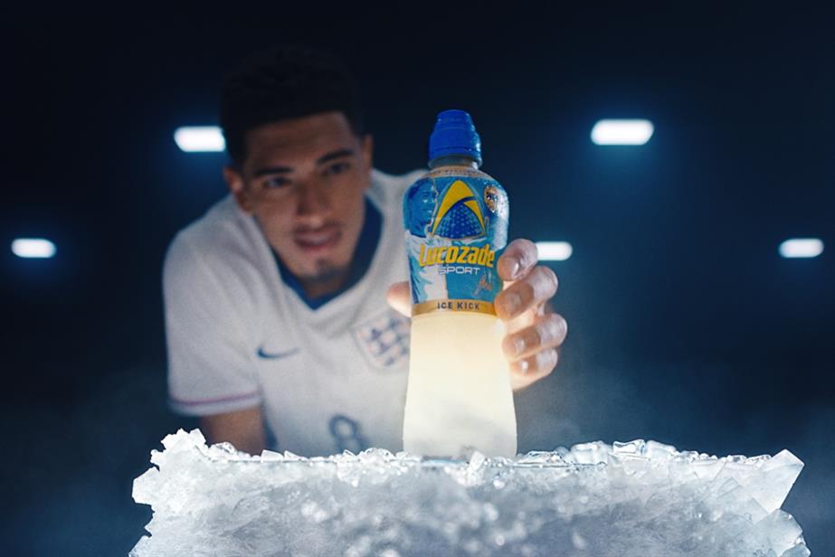 Jude Bellingham reaching out for bottle of Lucozade Sport Ice Kick drink on giant block of ice